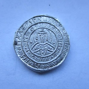 May include: A white ceramic mug with a black handle and the text "But First, Coffee" in a handwritten style. The mug is on a white surface. The mug is 4 inches tall.