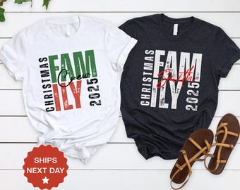 May include: Two t-shirts, one white and one charcoal, with the words "CHRISTMAS FAMILY 2025" in a vertical layout. The white shirt says "Crew" and the charcoal shirt says "Smith" in cursive. Brown sandals are next to the charcoal shirt.