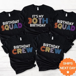 May include: Five black t-shirts with colorful text. Two shirts say "BIRTHDAY SQUAD", two say "BIRTHDAY CREW", and one says "IT'S MY 30TH BIRTHDAY". The text is in a retro font with rainbow colors.