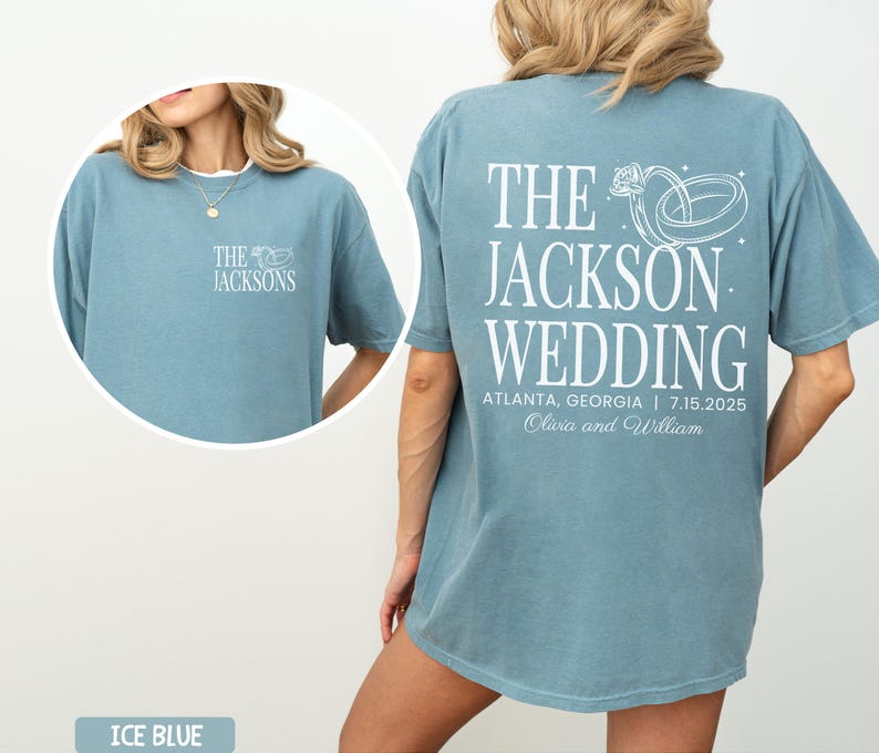 May include: Ice blue t-shirt featuring white text and a wedding ring design. The front displays "The Jacksons". The back reads "The Jackson Wedding, Atlanta, Georgia 7.15.2025, Olivia and William".