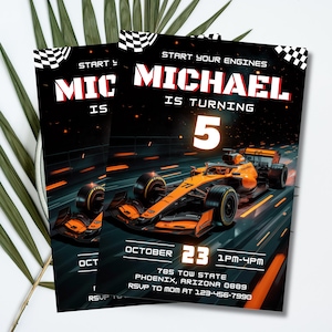 May include: Two black and orange race car themed birthday party invitations. The invitations feature a Formula 1 race car, the name "MICHAEL", and the number "5". The date and time of the party are also included.