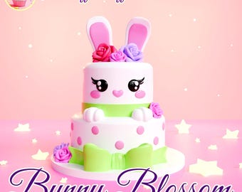 May include: A two-tiered cake decorated with a white bunny face, green ribbon, pink and white polka dots, and pink and purple flowers. The cake is on a white plate and has the text "Bunny Blossom" in purple letters on a pink background.