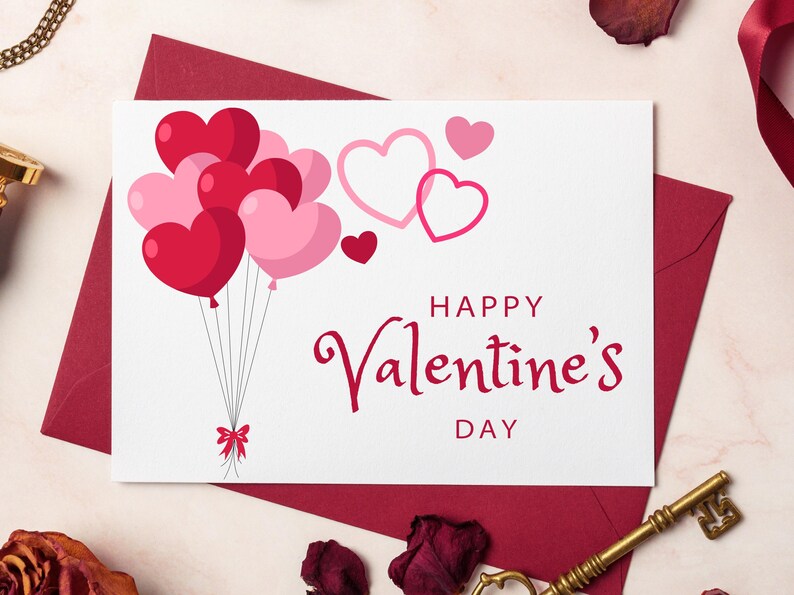 May include: A white card with a red and pink heart balloon design. The card says "Happy Valentine's Day".