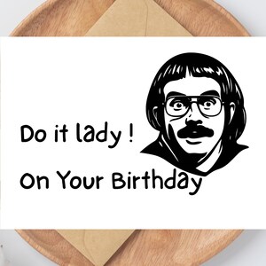 May include: A white greeting card with the text "Do it lady! On Your Birthday" and a black and white illustration of a man with glasses and a mustache. The card is on a wooden plate with a brown envelope.