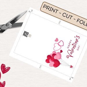May include: Printable Valentine's Day card featuring a design of pink and red heart-shaped balloons with the text "Happy Valentine's Day".