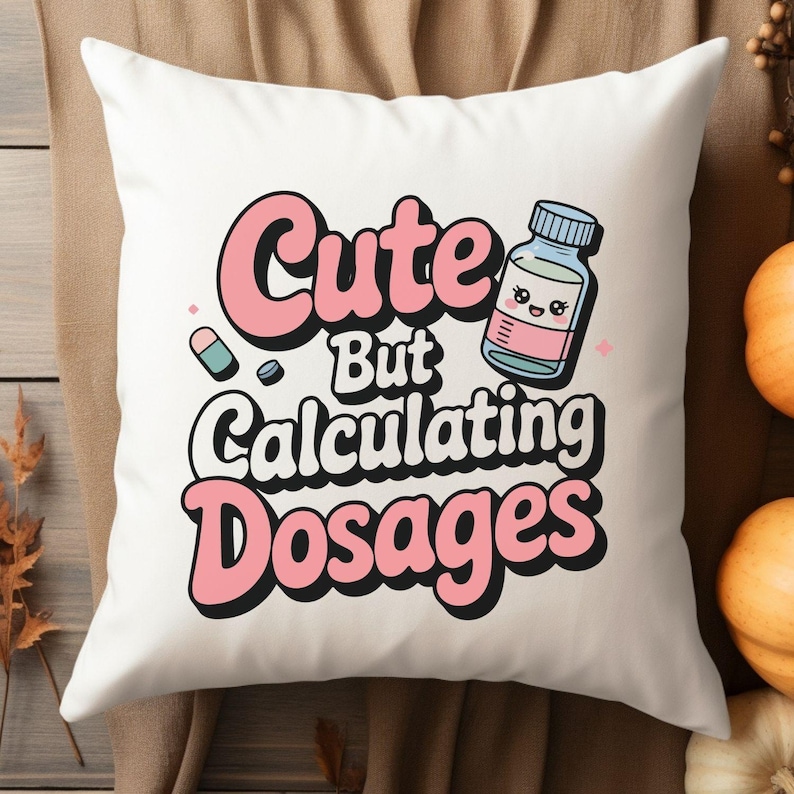 May include: White decorative pillow with the text "Cute But Calculating Dosages" in pink and white. The pillow features an illustration of a pill, a pill bottle, and a pink star.