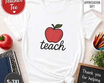 May include: White t-shirt featuring a red apple graphic and the word "teach" in black script. The shirt also has the text "Teacher Tee" and "Teacher Appreciation Gift". Sizes available are S-3XL. A chalkboard reads "Thank you for helping us grow!"