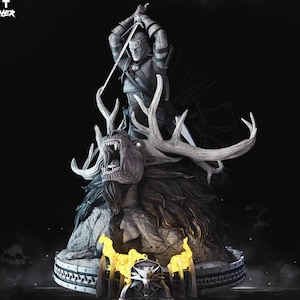 May include: A detailed statue of Geralt from The Witcher, wielding a sword above a monster with large antlers and an open mouth. The statue is predominantly gray with yellow flame accents and the text "GERALT THE WITCHER".