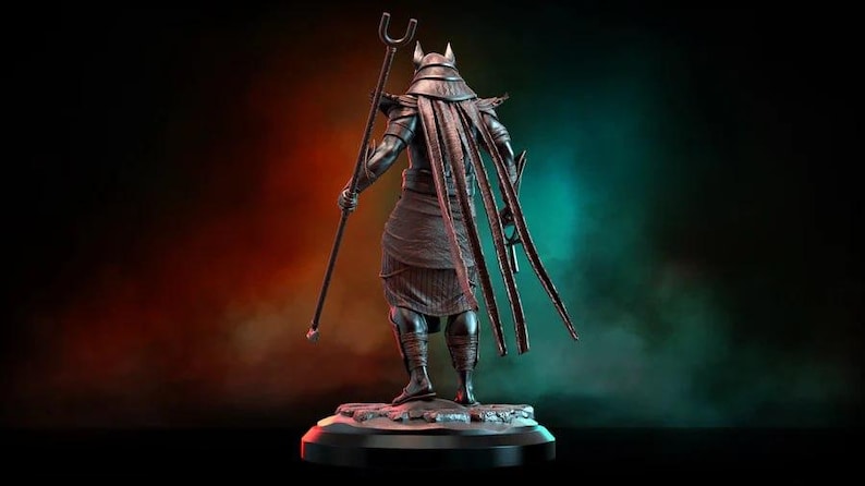May include: A dark statue of a figure with a jackal head, holding a staff. The figure wears a headdress and long, flowing elements. The statue is on a round base, set against a gradient background of red, green, and black.