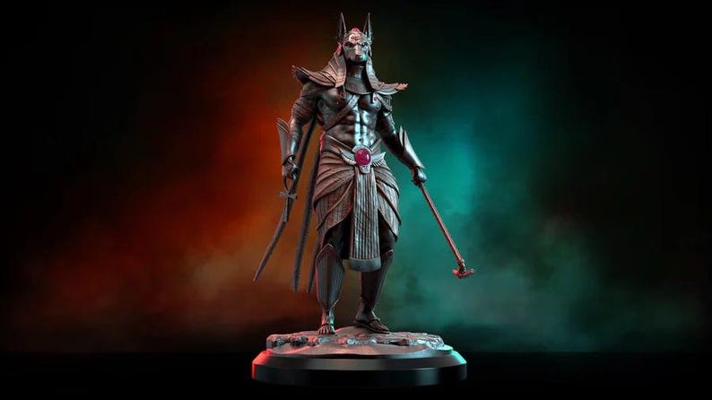 May include: A detailed statue of Anubis, the Egyptian god of the afterlife, depicted in a standing pose. The figure is metallic gray with intricate armor and a jackal head. It holds a sword and a staff, and is set against a gradient background.
