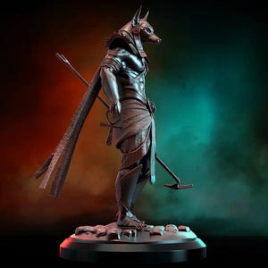 May include: A detailed sculpture of Anubis, the Egyptian god of the afterlife, depicted in a standing pose. The figure is dark metallic with a jackal head, holding a staff and a scepter. The sculpture is on a round base with a red light.