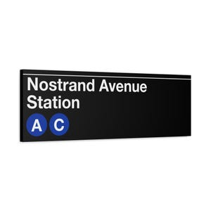 May include: Black and white sign with the text "Nostrand Avenue Station" in white. The sign has two blue circles with the letters "A" and "C" in white.