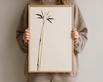 Könnte beinhalten: Ein gerahmter Wandkunstdruck mit einer minimalistischen Illustration von zwei schlanken Bambusstängeln vor einem einfarbigen, cremeweißen Hintergrund. Ein Stängel ist in tiefem Schwarz gehalten, der andere in einem Goldgelb, beide mit feinen Blättern.