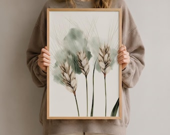 Könnte beinhalten: Ein rechteckiges gerahmtes Wandbild mit einer botanischen Illustration von drei Weizenähren. Die Ähren sind in Beige- und Brauntönen gehalten und vor einem cremefarbenen Hintergrund mit einem weichen, salbeigrünen Aquarellverlauf dargestellt.
