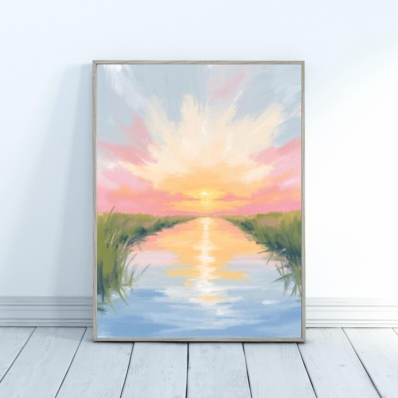 May include: A framed landscape painting depicting a sunset over a waterway. The artwork features a vibrant sky with pink, yellow, and orange hues, reflecting in the water. Green grass lines the waterway's edges, creating a serene and colorful scene.