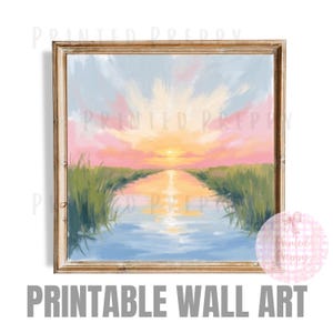 May include: A framed print of a sunset over a waterway, with a vibrant sky of pink, yellow, and blue hues. The water reflects the sky, and green reeds line the banks. The words "PRINTABLE WALL ART" are at the bottom.
