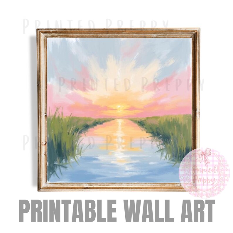 May include: A framed print of a sunset over a waterway, with a vibrant sky of pink, yellow, and blue hues. The water reflects the sky, and green reeds line the banks. The words "PRINTABLE WALL ART" are at the bottom.
