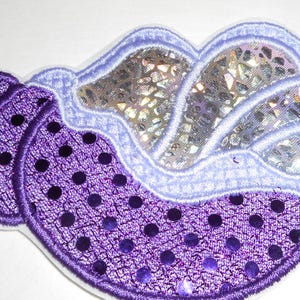 May include: Purple and iridescent sequined seashell patch with a white outline.