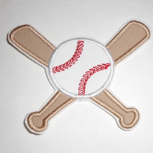May include: A white baseball with red stitching and two brown wooden bats crossed behind it.