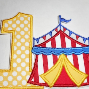 May include: A fabric patch featuring the number one in yellow with white polka dots, positioned next to a circus tent patch with red and white vertical stripes, a blue scalloped trim, yellow tent flaps, and a blue flag on top.