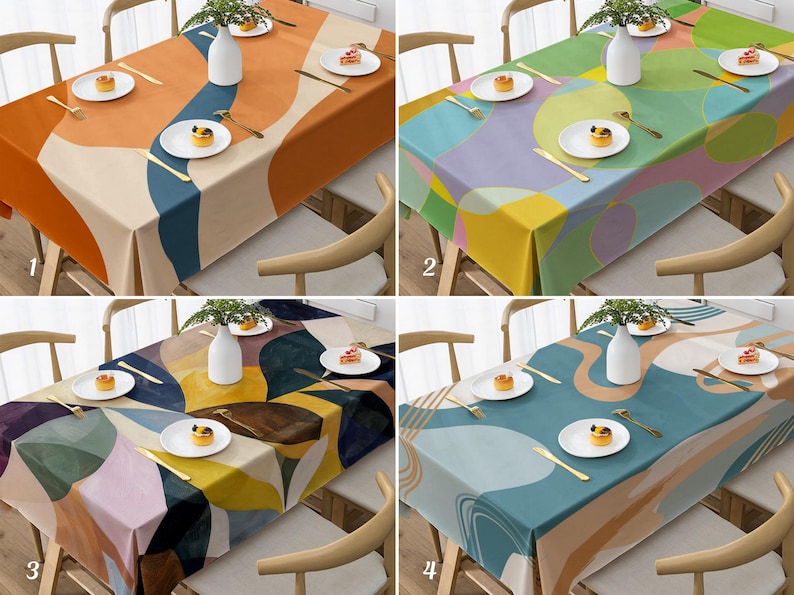 May include: Four colorful tablecloths with abstract designs are displayed on tables. Each tablecloth features a unique pattern of overlapping shapes in various colors, including orange, blue, green, purple, and yellow. Each table is set with white plates, silverware, and a small dessert.