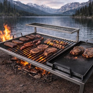 May include: A large, stainless steel outdoor grill with various cuts of meat cooking over an open flame. The grill includes a griddle and a warming rack. The scene is set near a lake with mountains in the background, suggesting a camping or outdoor cooking theme.