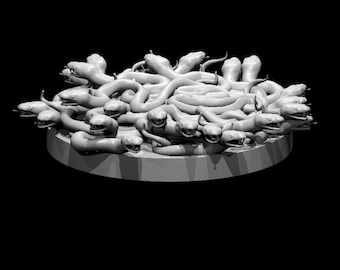 Può includere: Una scultura in scala di grigi con una base circolare ricoperta da numerose figure di serpenti. I serpenti sono arrotolati e intrecciati, con teste e bocche aperte visibili. Il testo "Photograph not to scale" è in basso.