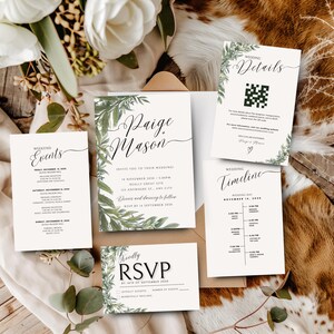 May include: A collection of wedding stationery, including invitations, RSVP cards, and details cards. The designs feature elegant calligraphy and botanical accents. The color palette is primarily white and green, with a rustic, natural aesthetic.