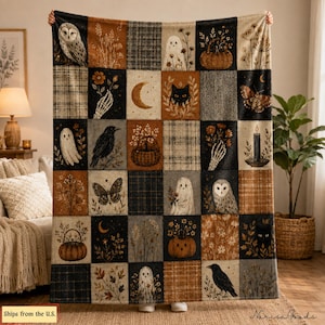 May include: A rectangular woven throw blanket featuring a grid of squares with illustrations of owls, ghosts, black cats, pumpkins, crows, moths, crescent moons, skeletal hands, candles, and floral arrangements in shades of black, brown, and cream.
