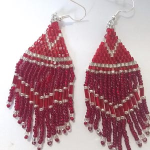 Red, silver glass beaded dangle earrings with red silver fringe. New artisan earrings. Handmade earrings.
