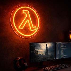 May include: A glowing orange neon sign displaying the lambda symbol, set against a dark wall. Beneath, a dual-screen monitor setup shows a landscape and code. A keyboard, mouse, and headphones are on the desk, creating a tech-focused space.
