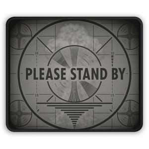 May include: A gray, rectangular patch featuring a vintage television test pattern with the words "PLEASE STAND BY" in bold, black letters. The design includes concentric circles, lines, and a textured background, framed by a black border.