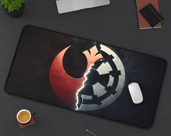 May include: Black rectangular desk mat featuring a split design with the Rebel Alliance symbol in red and the Galactic Empire cog in white. A white mouse sits on the mat, with a laptop and accessories in the background.