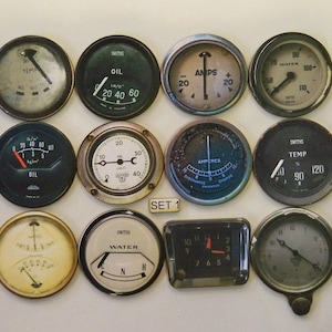 May include: Set of 12 vintage-style round gauges with black and white faces and chrome bezels. The gauges measure oil, water, temperature, and amps. The gauges are labeled with the brand name "Smiths".