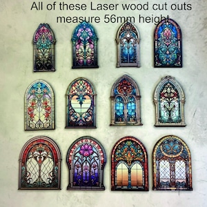 May include: A collection of laser-cut wooden stained glass window cutouts, each 5.6cm high. The colourful designs feature intricate patterns in shades of red, blue, green, and yellow. The text in the image says "All of these Laser wood cut outs measure 56mm height."
