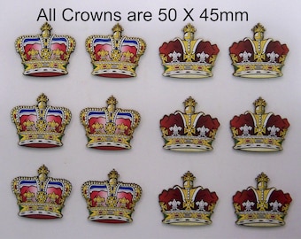 May include: Twelve colorful crown-shaped embellishments. Each crown is 50mm x 45mm and features a red, blue, and gold design with intricate details. The crowns have a regal appearance, suitable for crafts or decorative purposes.