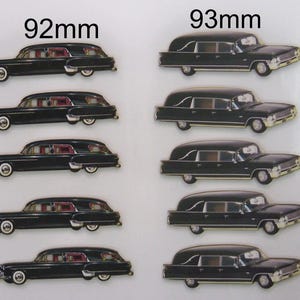 May include: A comparison of two different sizes of black hearse models. The model on the left is 92mm long, while the model on the right is 93mm long.