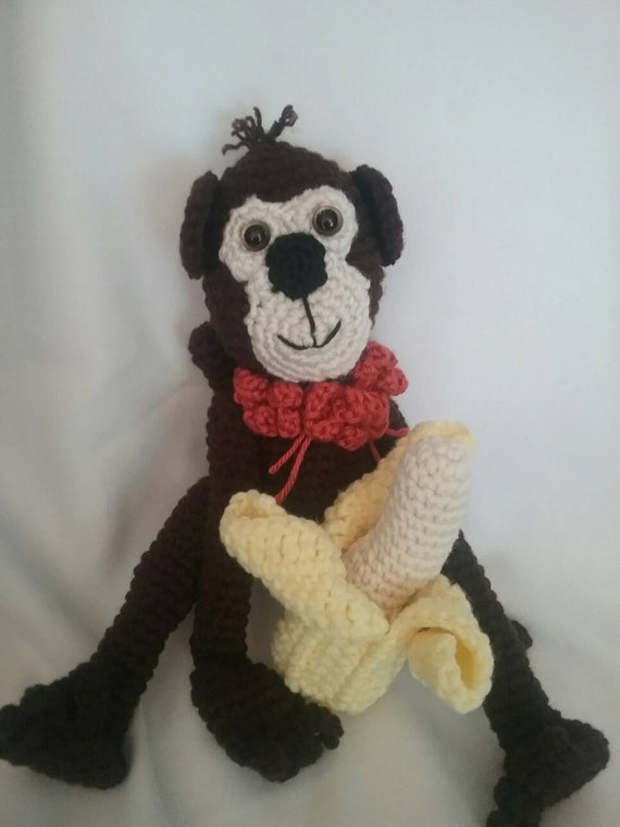 stuffed monkey with banana in hand