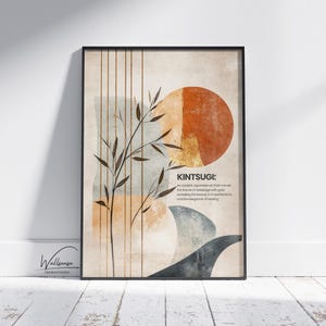 Puede incluir: Impresión de arte abstracto con fondo beige, que presenta una rama estilizada con hojas, un gran sol naranja y una forma abstracta azul y gris. La impresión incluye el texto "KINTSUGI: Un antiguo arte japonés que repara las huellas de la rotura con oro, revelando la belleza de las imperfecciones y la elegancia de la curación."