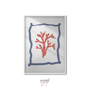 May include: Framed art print featuring a coral-like design in shades of red and white, set against a light gray background. The artwork is enclosed within a blue border and a white frame. The print has a minimalist aesthetic.