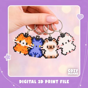 May include: Four pixel art cat keychains attached to silver metal rings. The cats are orange, blue, cream with brown accents, and white with pink ears. The text COZY DESIGNS and DIGITAL 3D PRINT FILE is visible at the bottom of the image.