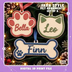 May include: A set of three Yarn Style Pet Ornaments featuring a paw print labeled Bella, a cat head labeled Leo, and a bone shape labeled Finn. Each ornament has a rope-textured border and a hanging ribbon in red, green, or blue.