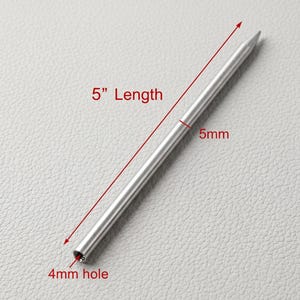 May include: A silver metal tool with a pointed end and a 4mm hole. The tool is 12.7 cm long and 5mm wide. The text "5" Length" and "5mm" and "4mm hole" are visible.