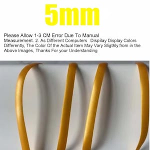 May include: Close-up of three strands of golden-yellow ribbon, each approximately 5mm wide. The image includes text at the top indicating the ribbon's width and a disclaimer about measurement and color variations.