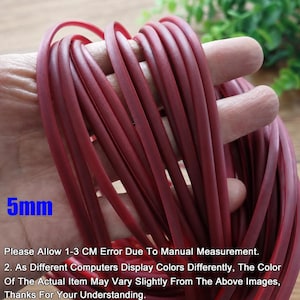 May include: A bundle of maroon-colored rubber tubing, approximately 5mm in diameter, is held in a hand. The text "5mm" is visible in the lower left corner. The image also includes text about measurement error and color variations.