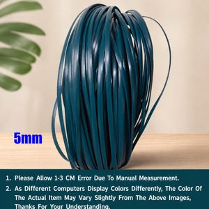 May include: A coil of teal-colored, flat, 5mm wide material. The material is tightly wound, creating a cylindrical shape. The image includes text at the bottom, which states that the color may vary slightly and to allow for a 1-3 cm error due to manual measurement.