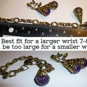 May include: A gold chain bracelet with a purple stone pendant and matching clip-on earrings. The bracelet measures 7-8 inches and is too large for a smaller wrist.