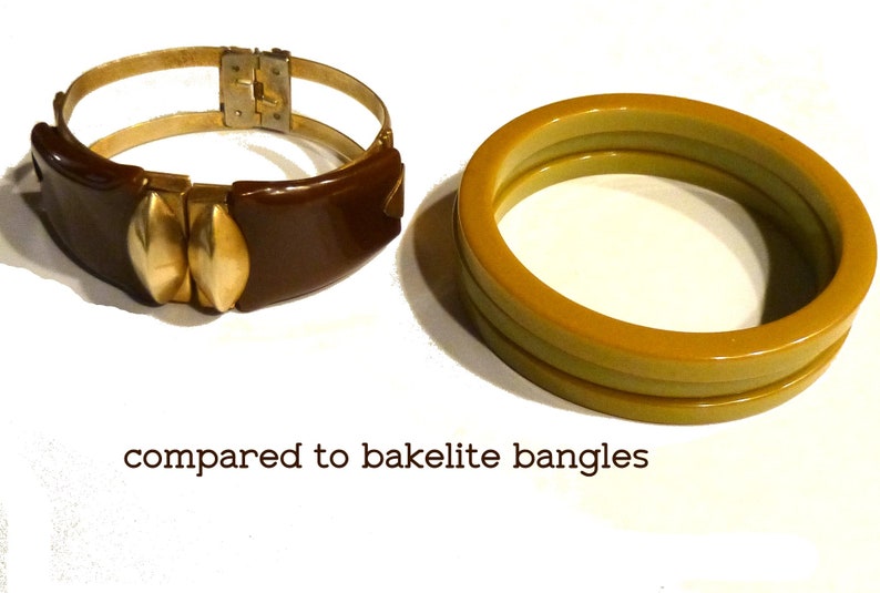 May include: Two bracelets, one brown with gold accents and a hinged clasp, and one yellow bakelite bangle.