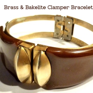 May include: A brown Bakelite and brass clamper bracelet. The bracelet has two large, rounded, brown Bakelite pieces with gold-toned metal accents. The bracelet is closed with a brass hinge.
