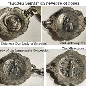 May include: A silver-toned metal rosary chain featuring four distinct circular links with scalloped edges. Each link displays a relief image of a religious figure, including Mater Dolorosa, Saint Anthony of Padua, Our Lady of the Immaculate Conception, and the Miraculous Medal with the text Holy Mary Pray For Us.